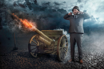 Businessman firing with old cannon