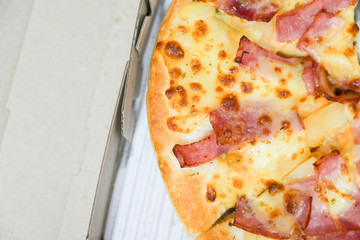 Close up of hawaiian pizza with boiled ham and pineapple.