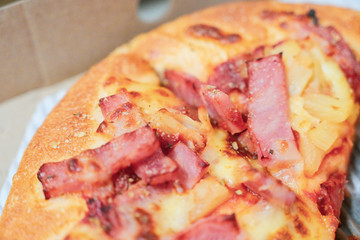 Close up of hawaiian pizza with boiled ham and pineapple.
