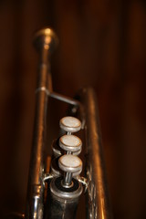 Fototapeta premium The trumpet valves on the brown background