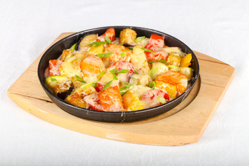 Baked salmon with potato in pan