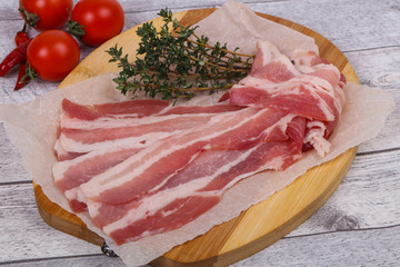 Raw bacon on the board