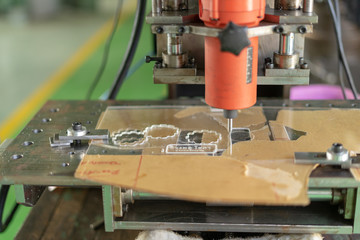 DIY Mini CNC Machine for 3D carving. Process of 3D cutting, machining and sculpting. Cutting 3D text on the workpiece
