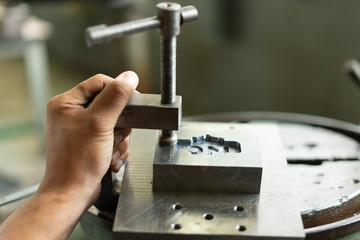 Close up of man using a C clamp