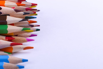 Fototapeta premium Colored pencils, school supplies for drawing, pattern, copy space.