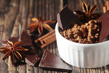 Cocoa powder and a bar of dark chocolate