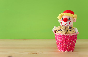 Purim celebration concept (jewish carnival holiday) over wooden table