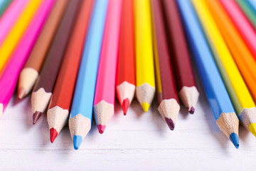 Colored pencils, school supplies for drawing, pattern, copy space.