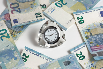Banknotes on a white background and a clock in the middle