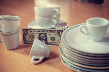 older dishes set with money on the floor