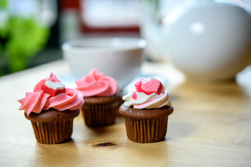 pink and white muffins with heart and teapot