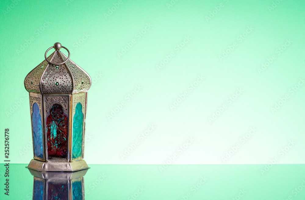 Sticker Ramadan lantern or Arabic decoration lamp on green background. Selective focus