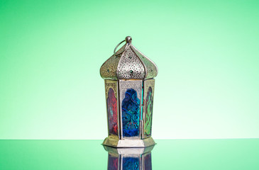 Ramadan lantern or Arabic decoration lamp on green background. Selective focus