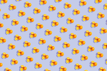 Oranges on a bright colored blue background. Repeating pattern, preparation for wallpaper citrus mood.