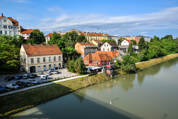 Fototapeta na wymiar Maribor city, Slovenia. Drava River, buildings and Alps mountains of Maribor.