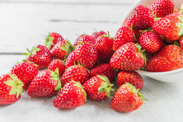 Stack of strawberries on white wooden desk.