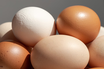 Plain multicoloured free range eggs on wooden plate
