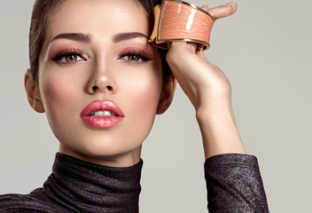 Beautiful  fashion woman with living coral lipstick. Attractive white girl wears luxury jewelry.