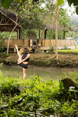 Filipino girl yoga posing in tropical jungle rice fields