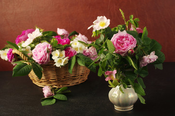 Bouquets of roses in vases and baskets