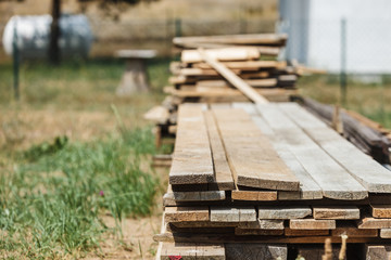 Fototapeta na wymiar Stack of wooden piles plank boards
