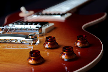 Close Up Photo of Volume and Tone Controls of Electric Guitar