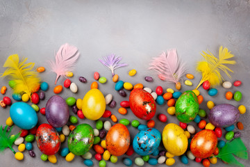 Colorful Easter eggs and chocolate Easter sweets.
