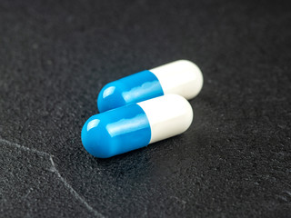 Two blue and white capsules