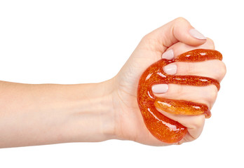 kid playing orange slime with hand, transparent toy