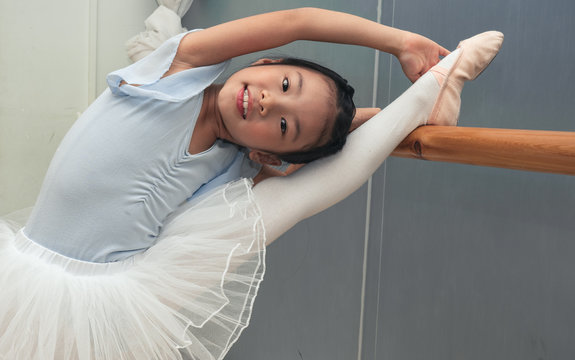 Chinese small ballerina does exercise at ballet school