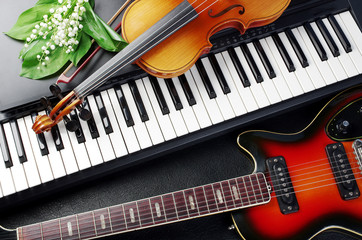Keyboard synthesizer, violin, guitar and a bouquet of flowers