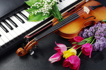 Keyboard synthesizer, violin and a bouquet of flowers