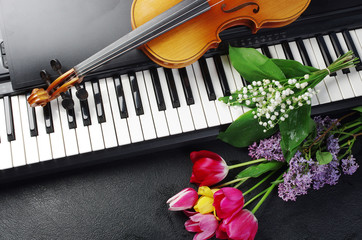 Keyboard synthesizer, violin and a bouquet of flowers