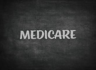 Fototapeta premium medicare concept word on a blackboard background
