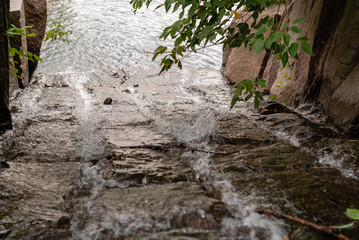 Fast stream running down the artificial granite creek bed