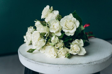 Bouquet with white roses on green background of natural light background
