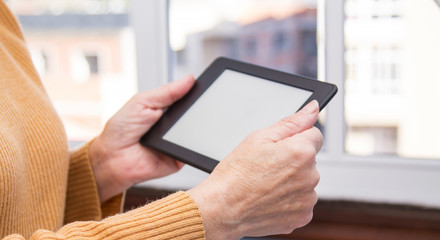woman's hands working with digital tablet
