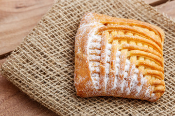 Cake with cottage cheese on canvas on a wooden table