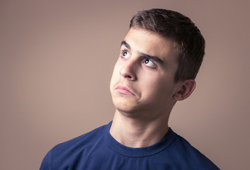 Obraz premium Closeup portrait confused young man. Human facial expression, emotion, feeling, sign symbol body language