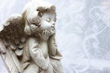 sitting stone angel on white background patterns