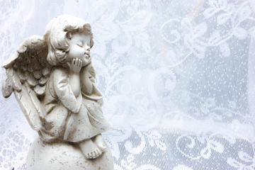 sitting stone angel on white background patterns