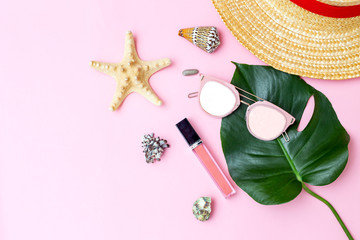 Travel feminine accessories on pink background. Copy space