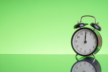Alarm Clock on green background with selective focus. Copy space  and business concept