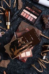 set of cosmetics and nature chocolate on black background  in frame .