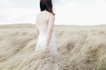 Rear view of woman standing in field
