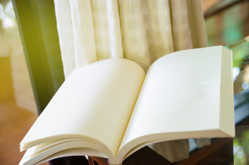 open book on glass table