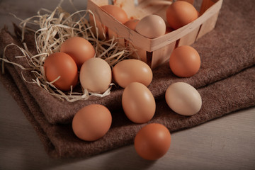  Chicken eggs are scattered randomly on a dark background.