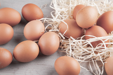  Chicken eggs are randomly scattered on a light background.