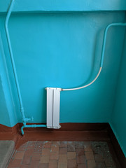A White heating radiator on the wall.