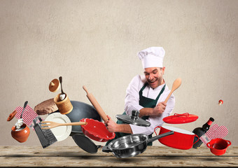 Cheerful chef drumming on pots and pans